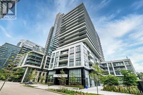 Toronto (Mimico) condo for rent - A modern multi-story building with a glass facade and a parking lot in front.