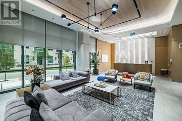 Toronto (Mimico) condo for rent - A living room with a grey sofa and a coffee table.