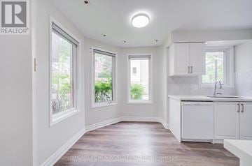 Toronto (Malvern) townhouse for rent - A white kitchen with a sink and cabinets.