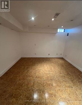 Toronto (Centennial Scarborough) apartment for rent - A room with a wooden floor and white walls.