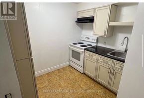 Toronto (Centennial Scarborough) apartment for rent - A small kitchen with a stove, sink, and cabinets.