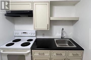Toronto (Centennial Scarborough) apartment for rent - A white stove and sink in a small kitchen.