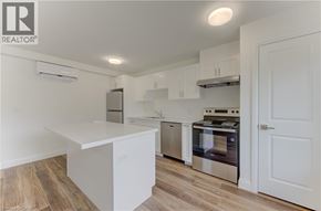 Kitchener apartment for rent - A modern kitchen with white cabinets and stainless steel appliances.