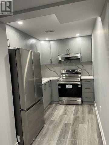 Barrie (Georgian Drive) apartment for rent - A kitchen with a stainless steel refrigerator and wooden flooring.