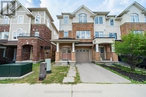 Hamilton (Stoney Creek Mountain) townhouse for rent - A row of townhouses with a sign that says "HOMELIFE/MIRACLE REALTY LTD, Brokerage".