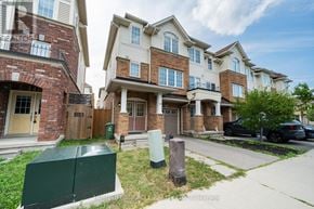 Hamilton (Stoney Creek Mountain) townhouse for rent - A row of townhouses with a green dumpster in front of the first one.