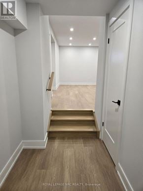 Niagara Falls (Brown) apartment for rent - A hallway with wooden floors and white walls.