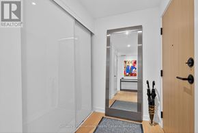 Collingwood condo for rent - A hallway with a glass door and a wooden door.