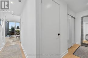 Collingwood condo for rent - A hallway with a rug on the floor and a door on the right.