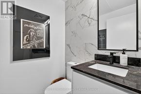 Collingwood condo for rent - A bathroom with a poster of The Rolling Stones on the wall.