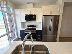Ottawa multi-family for rent - A kitchen with a sink, stove, and refrigerator.