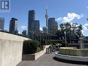 Toronto (Waterfront Communities) condo for rent - A view of a city skyline with a tall tower in the background.