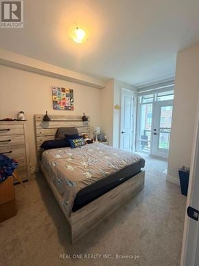 Oakville (Jm Joshua Meadows) townhouse for rent - A bedroom with a bed, dresser, and a window.