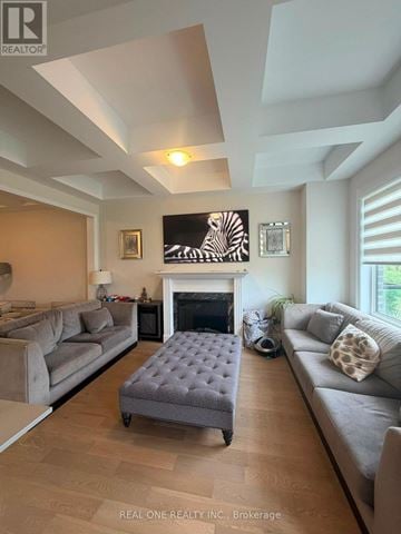 Oakville (Jm Joshua Meadows) townhouse for rent - A living room with a grey couch and a fireplace.