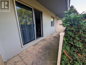 London South (South M) condo for rent - A balcony with a view of trees and a building.