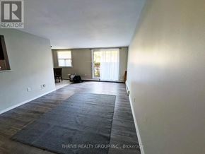London South (South M) condo for rent - A room with a rug on the floor and a window with curtains.
