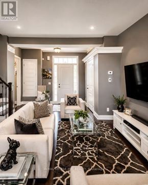 Niagara-On-The-Lake (Town) townhouse for rent - A living room with a white couch and a glass coffee table.