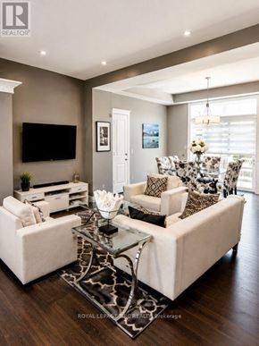 Niagara-On-The-Lake (Town) townhouse for rent - A living room with a white couch and a glass coffee table.