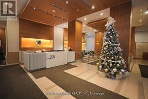 Toronto (Waterfront Communities) condo for rent - A Christmas tree is placed in the lobby of a building.