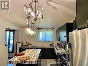 Toronto (Willowridge-Martingrove-Richview) apartment for rent - A well-lit kitchen with a wooden countertop and a stainless steel refrigerator.