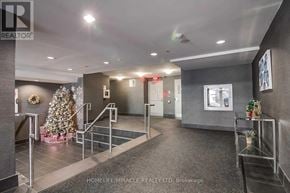 Toronto (Dovercourt-Wallace Emerson-Junction) condo for rent - A lobby with a Christmas tree and a staircase.