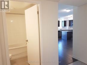 Toronto (Dovercourt-Wallace Emerson-Junction) condo for rent - A bathroom with a toilet and a bathtub is shown with the door open.