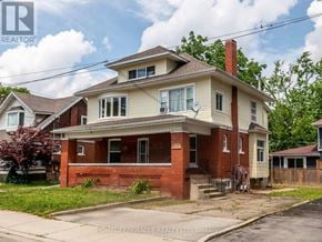 Niagara Falls (Cherrywood) apartment for rent - A two-story house with a red brick exterior and a white front porch.