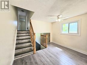 Cambridge apartment for rent - A room with a staircase leading to the upper floor.