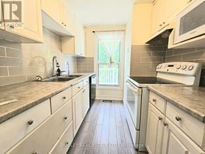 Cambridge apartment for rent - A kitchen with a white oven and wooden floors.