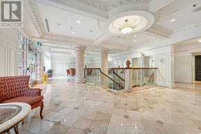 Toronto (Willowdale East) condo for rent - A large, well-lit foyer with a marble floor and a staircase with a metal railing.