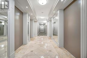 Toronto (Willowdale East) condo for rent - A long hallway with marble floors and white walls.