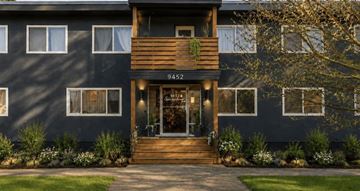 Chilliwack apartment for rent - A modern house with a dark facade and a wooden front door.