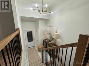 Paradise multi-family for rent - A virtual staging image of a home interior with a foyer, staircase, and a chandelier.