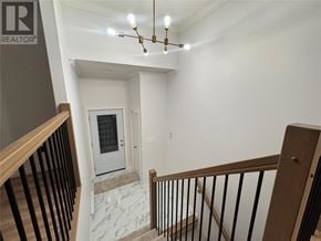 Paradise multi-family for rent - A staircase with a marble floor and a chandelier.