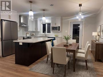 Paradise multi-family for rent - A modern kitchen with a dining table and chairs.