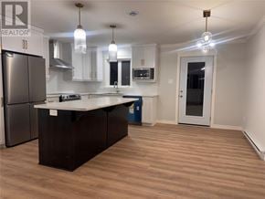 Paradise multi-family for rent - A kitchen with a black island and stainless steel appliances.
