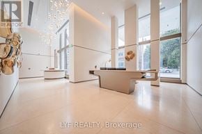 Toronto (Annex) condo for rent - A reception area with a white reception desk and a chandelier hanging from the ceiling.