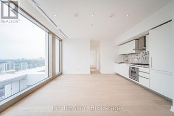 Toronto (Annex) condo for rent - A spacious, modern kitchen with white cabinets and a marble backsplash.