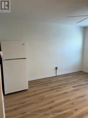 Thorold (Thorold Downtown) apartment for rent - A white refrigerator in a room with wooden flooring.