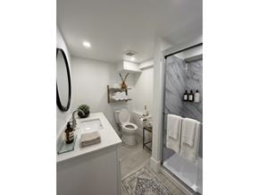Chilliwack apartment for rent - A bathroom with a white sink, toilet, and a mirror.