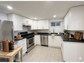 Chilliwack apartment for rent - A modern kitchen with white cabinets and stainless steel appliances.