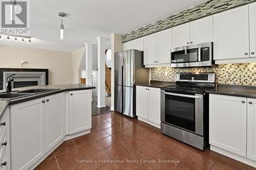 Collingwood apartment for rent - A kitchen with white cabinets and black countertops.