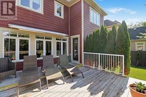 Collingwood apartment for rent - A red house with a white fence and a deck with chairs.