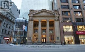 Toronto (Church-Yonge Corridor) condo for rent - A building with a large entrance and pillars in front of a HomeSense store.