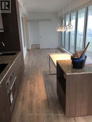 Toronto (Church-Yonge Corridor) condo for rent - A kitchen with a counter and a brokerage sign.