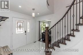 Barrie (West Bayfield) apartment for rent - A staircase with a metal railing and a light on the ceiling.