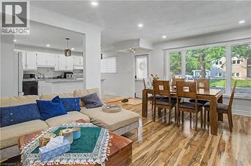 Burlington apartment for rent - A well-lit, spacious living room with a dining table and chairs.