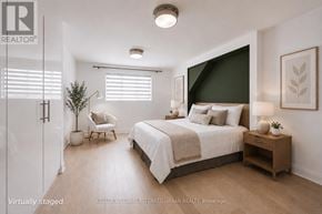 Toronto (Danforth Village-East York) apartment for rent - A bedroom with a bed, chair, and nightstand.