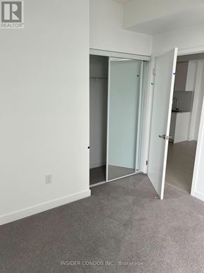 Toronto (Humber Heights) condo for rent - A room with a white wall and a grey carpet.