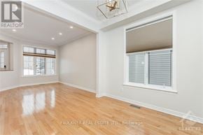 Ottawa apartment for rent - A room with wooden flooring and a window with blinds.
